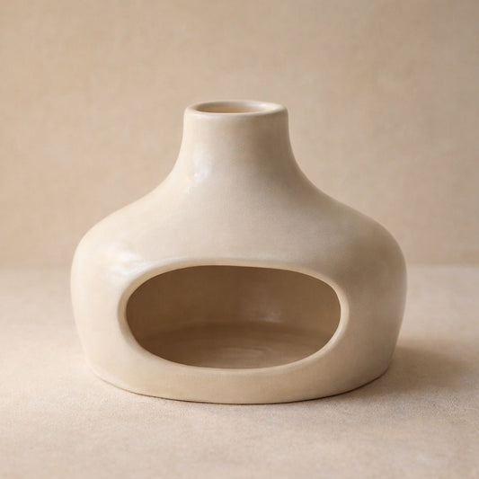 Sage – Cream ceramic burner with an oval opening and narrow chimney neck, shown against a plain beige background